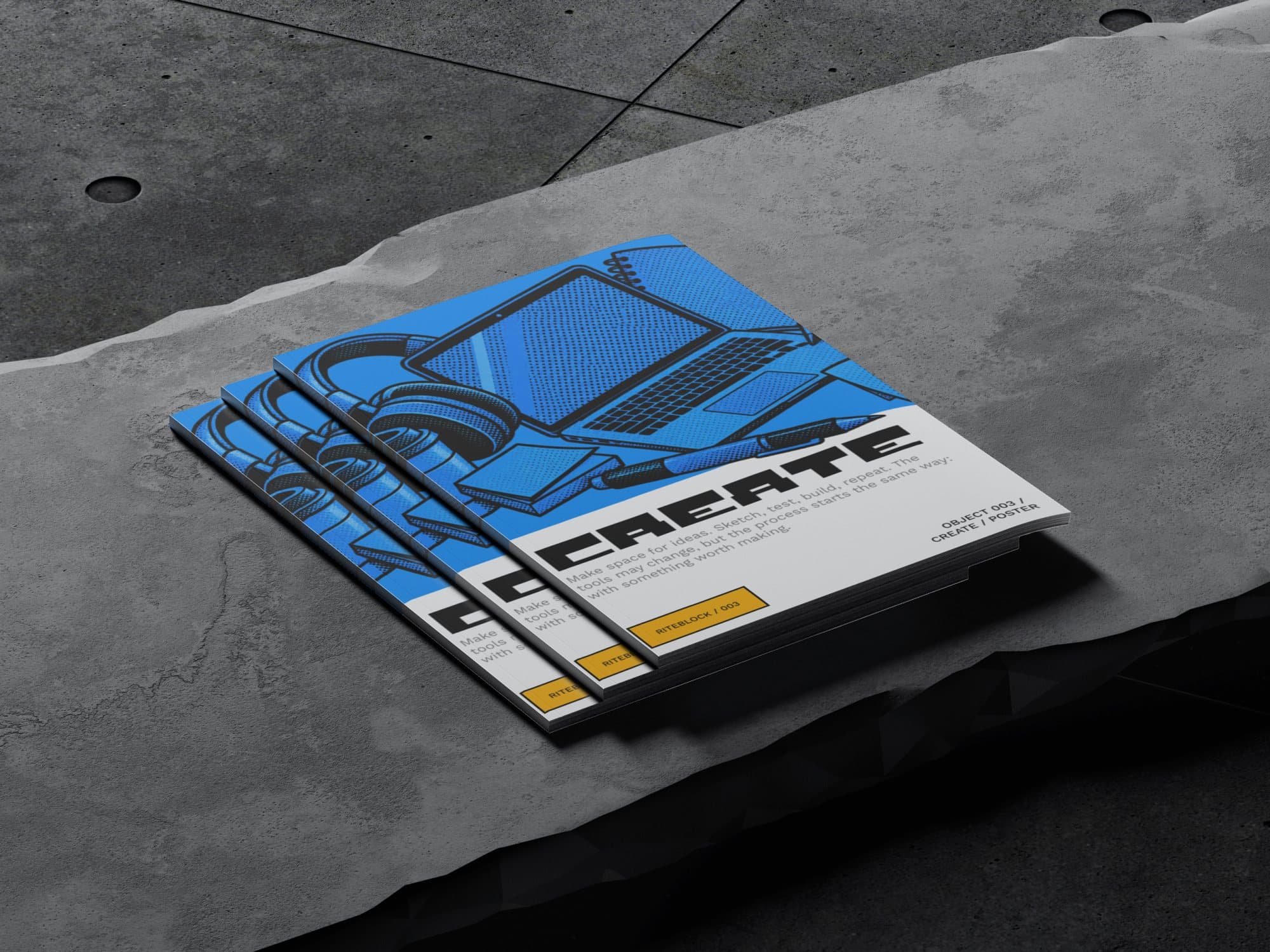 Three magazines fanned out on a concrete slab, each with CREATE in black Riteblock under a blue halftone drawing of a laptop and headphones.